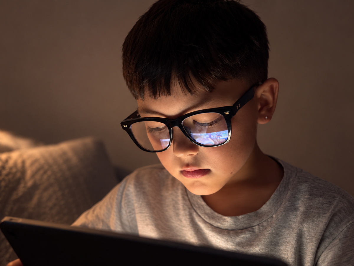 Ogi in a moody lifestyle scene wearing Square Eyes glasses, on and off screen